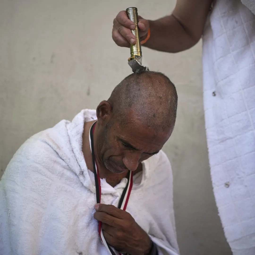 Pilgrim head shaving ritual after Hajj rites in Saudi Arabia